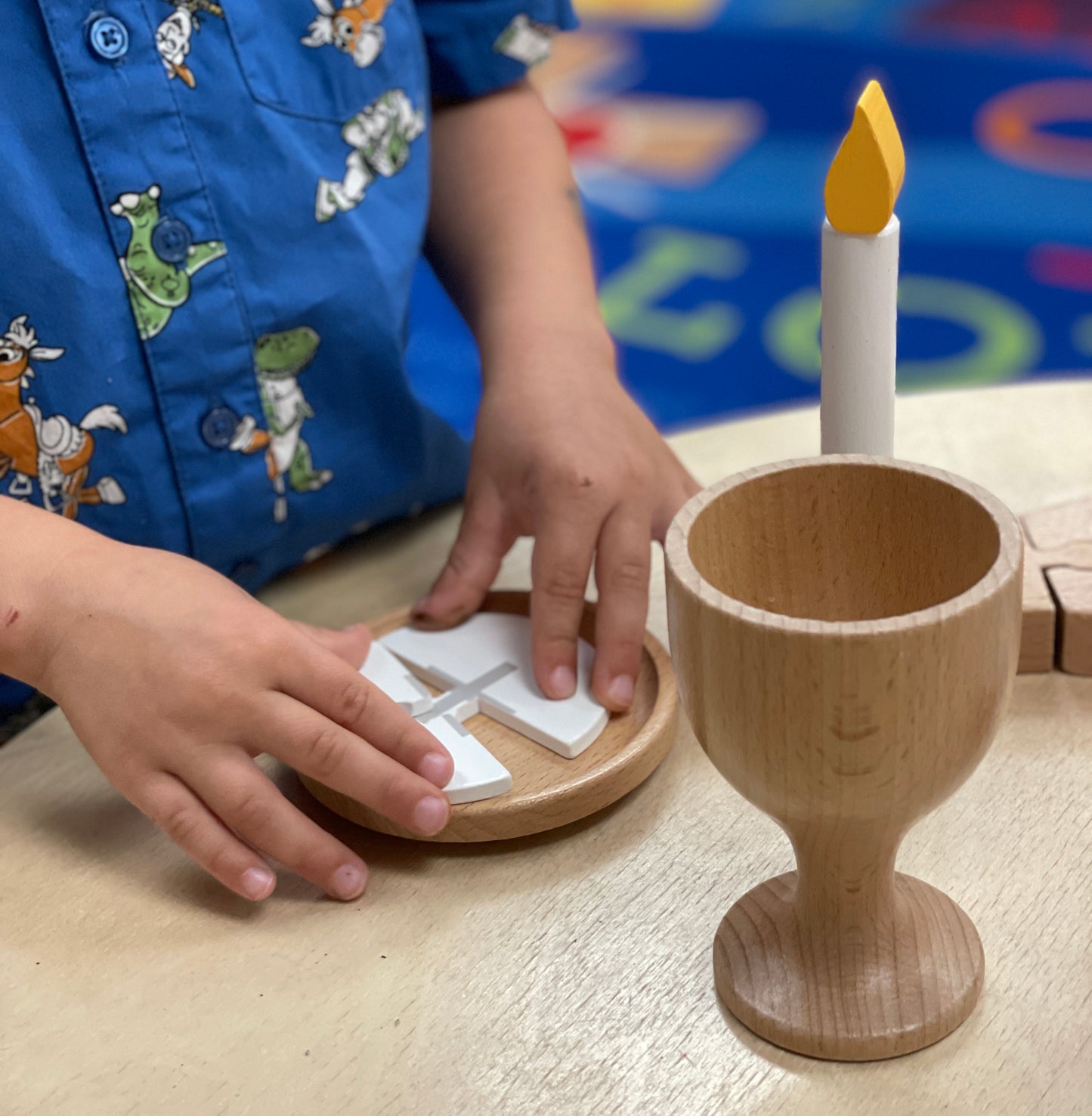 young boy playing with catholic mass set