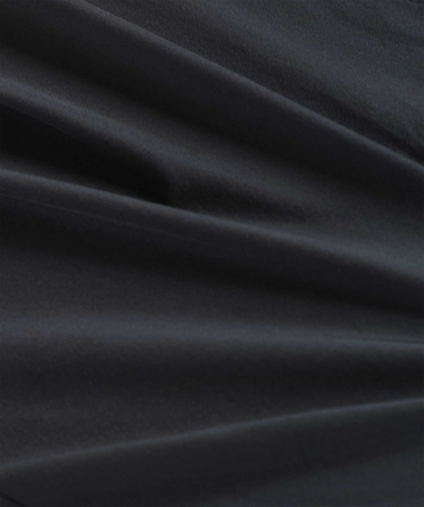 Close-up of dark black fabric with folds for the neckband clergy shirt