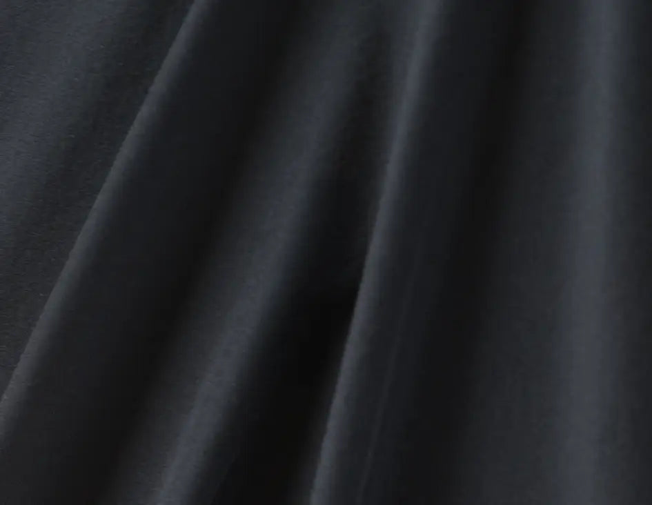 black cloth fabric with creases showcasing the stretchy performance of the wicking vicar clergy shirts