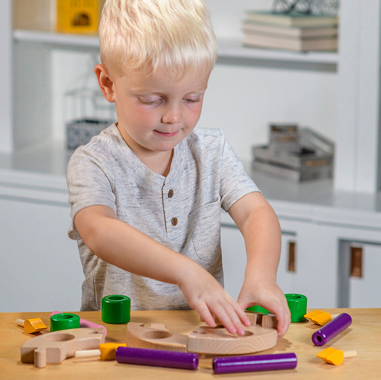 child playing with wicking vicar wooden church play set